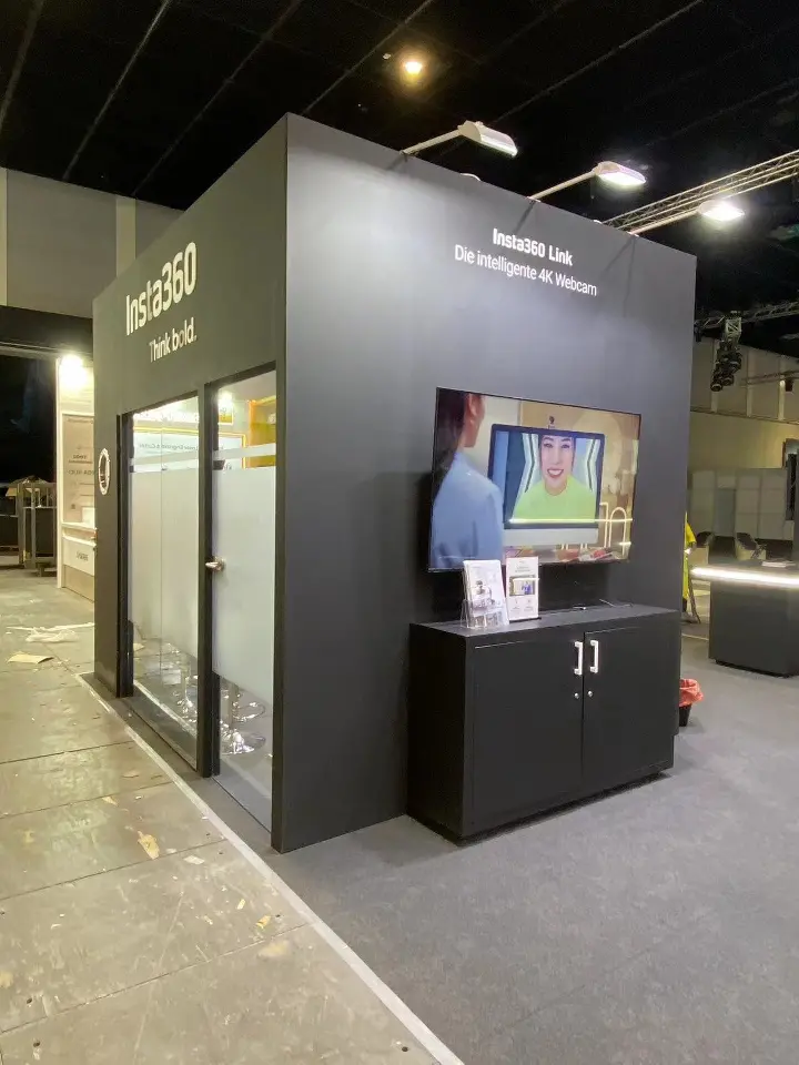 Black tower with a glass-door room and a small screen above a black cabinet