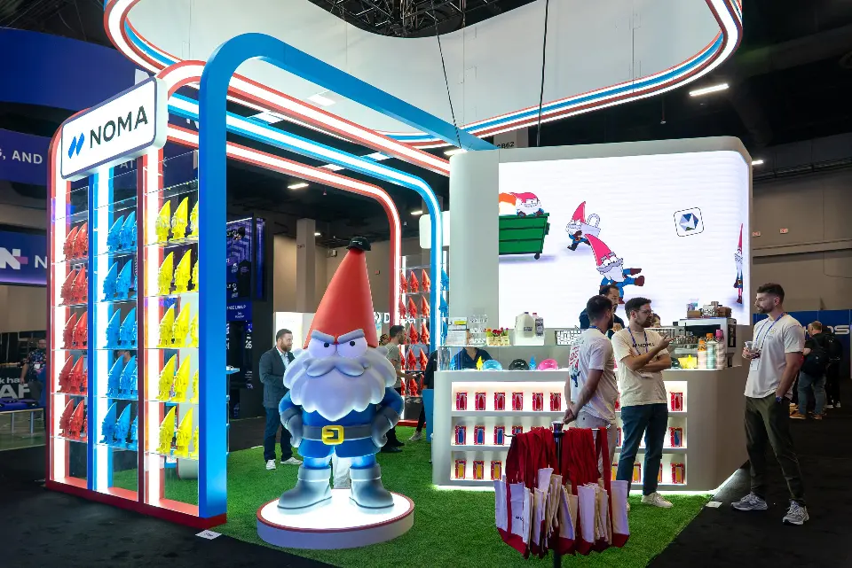Giant gnome statue on a lit base beside the counter and visitors