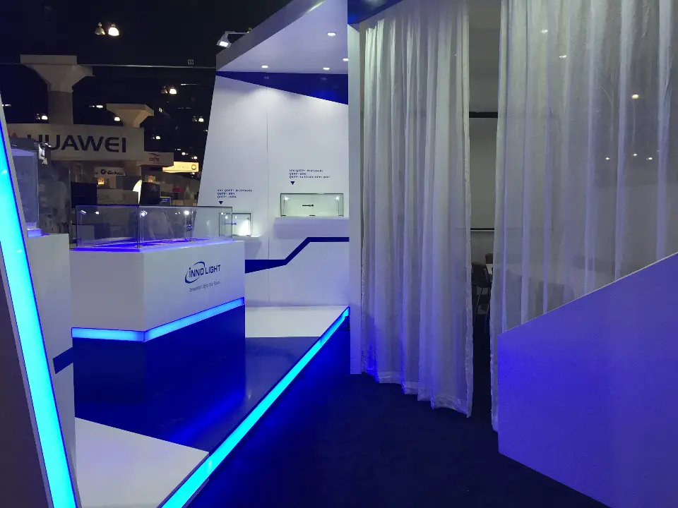 Display case and sheer curtains beside a blue lit edge
