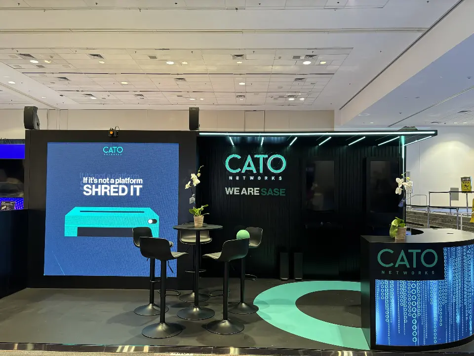 Video screen showing SHRED IT message beside the teal floor ring and curved counter