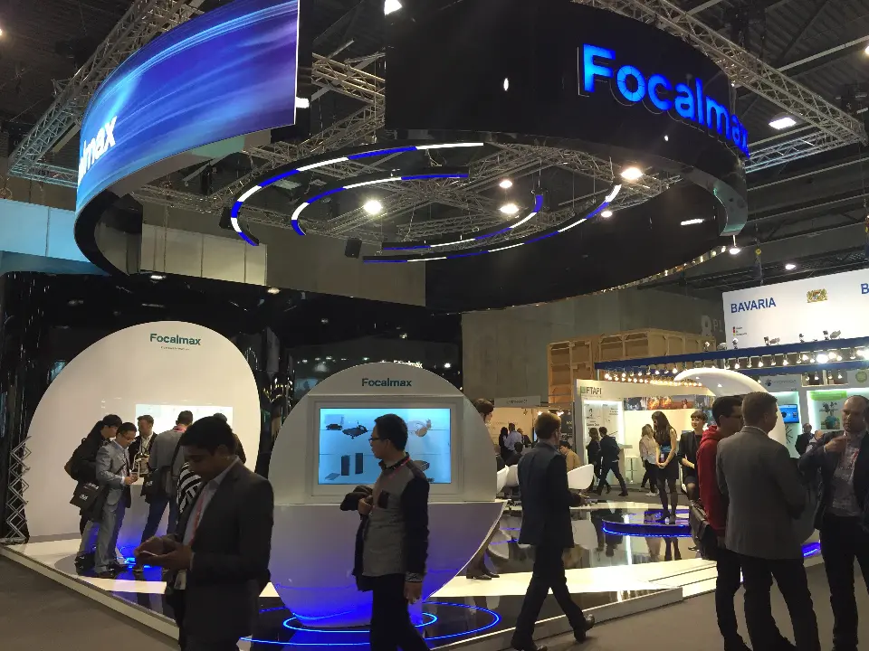 Visitors around the Focalmax kiosks during MWC 2016, with the lit underside of the hanging ring above
