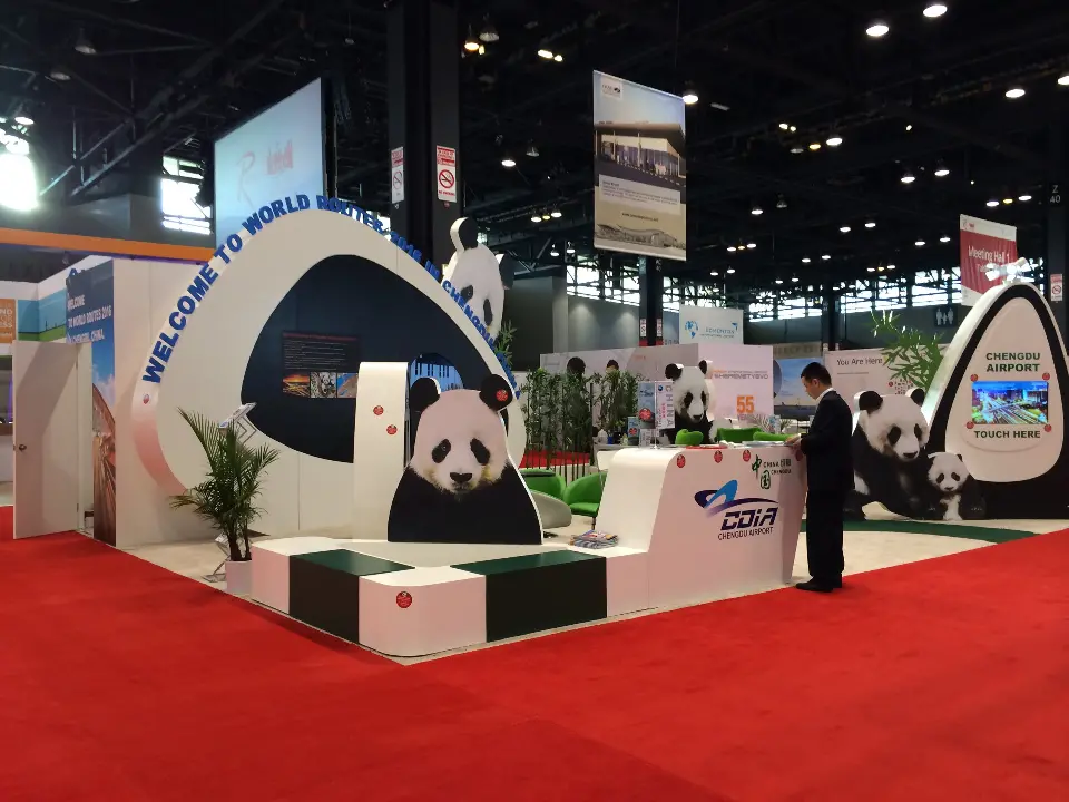 Finished panda-themed booth on red carpet with arch, palms and white benches