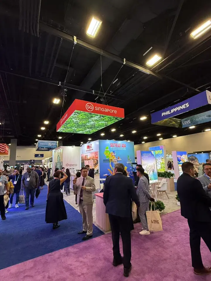 Crowded aisle view of the stand with the red canopy above