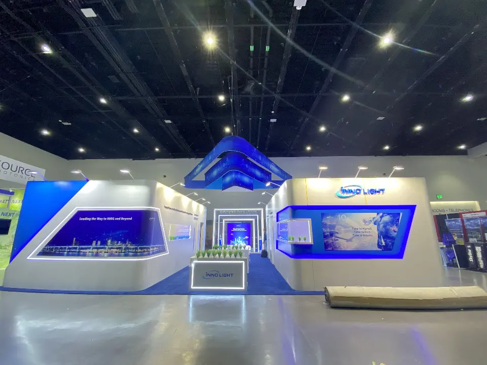 Low-angle view of curved white counters with glass showcases under the hanging frame