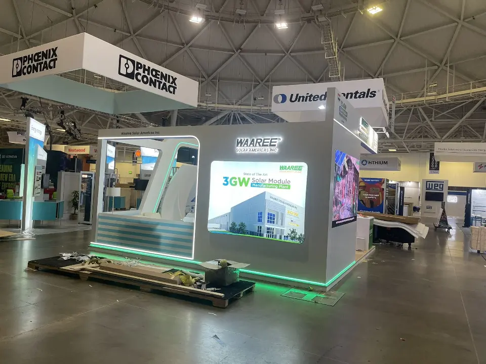 Side view of the booth with panel graphic, green trim and the WAAREE header