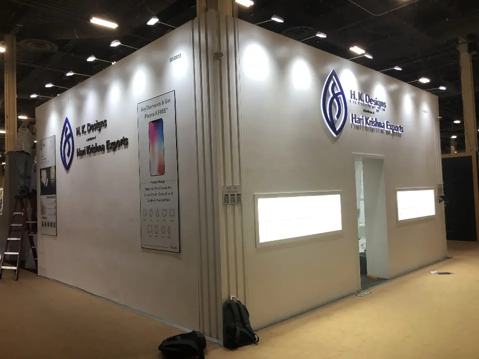 Warm-toned view of the booth front with spotlights on the leaf logo