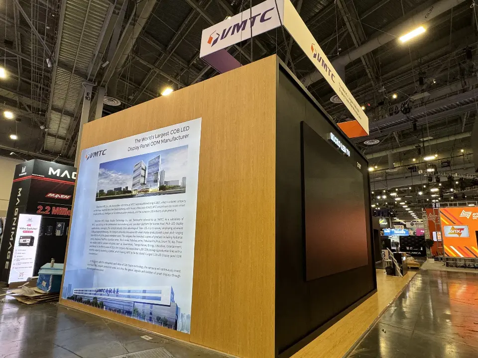 Wood-look side wall with a company story graphic and the VMTC header above the corner