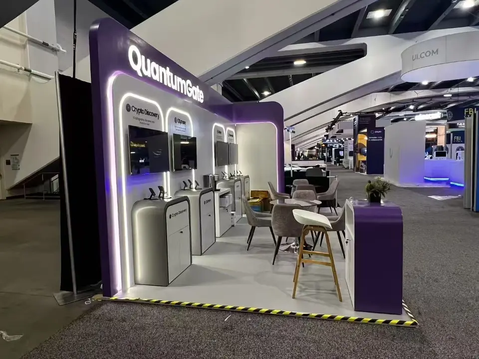 Side angle along the QuantumGate stand showing the purple end panel, high table and product pedestals