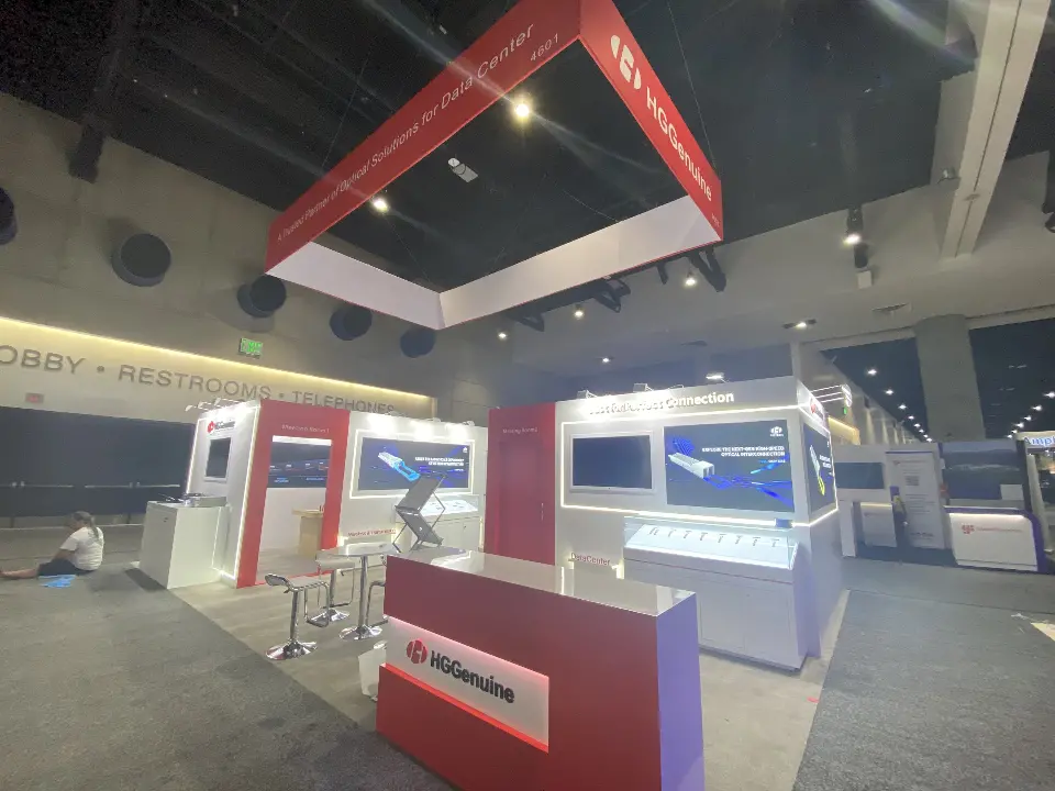 Red reception counter in front of white walls with backlit optical product graphics