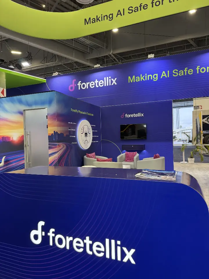 Close portrait of the welcome counter logo with the booth behind