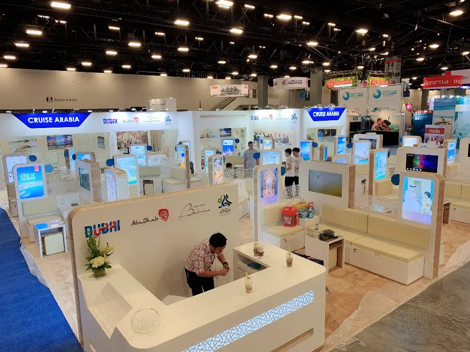 Reception counter with a staff member seated and lounge pods behind