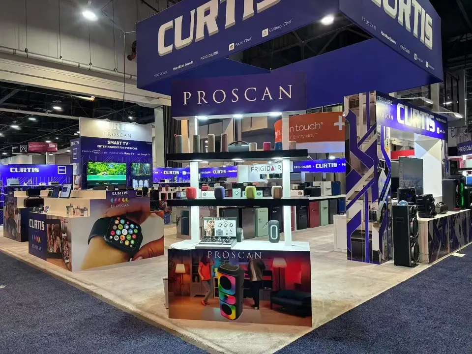 Other side of the Curtis stand at CES 2025 with a Proscan header and speaker display shelves