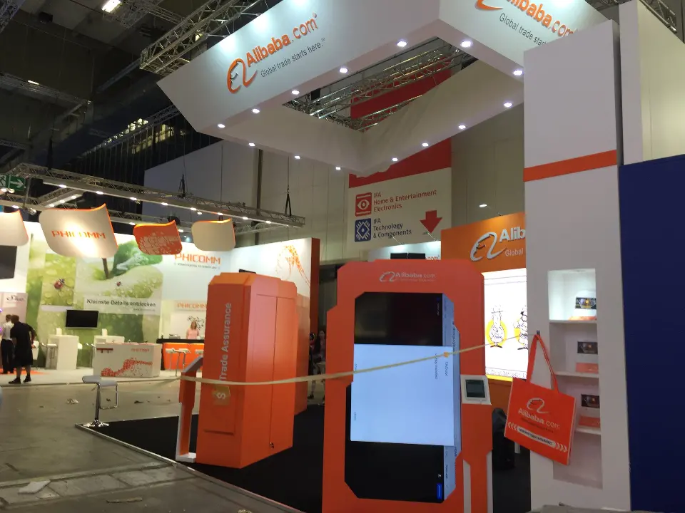 Side view of an orange frame holding a tall phone-style screen beside white walls