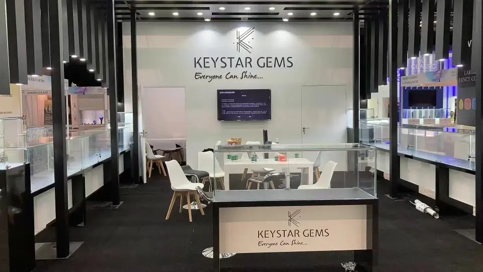 Front view of the Keystar Gems back wall, wall screen, meeting table and front showcase