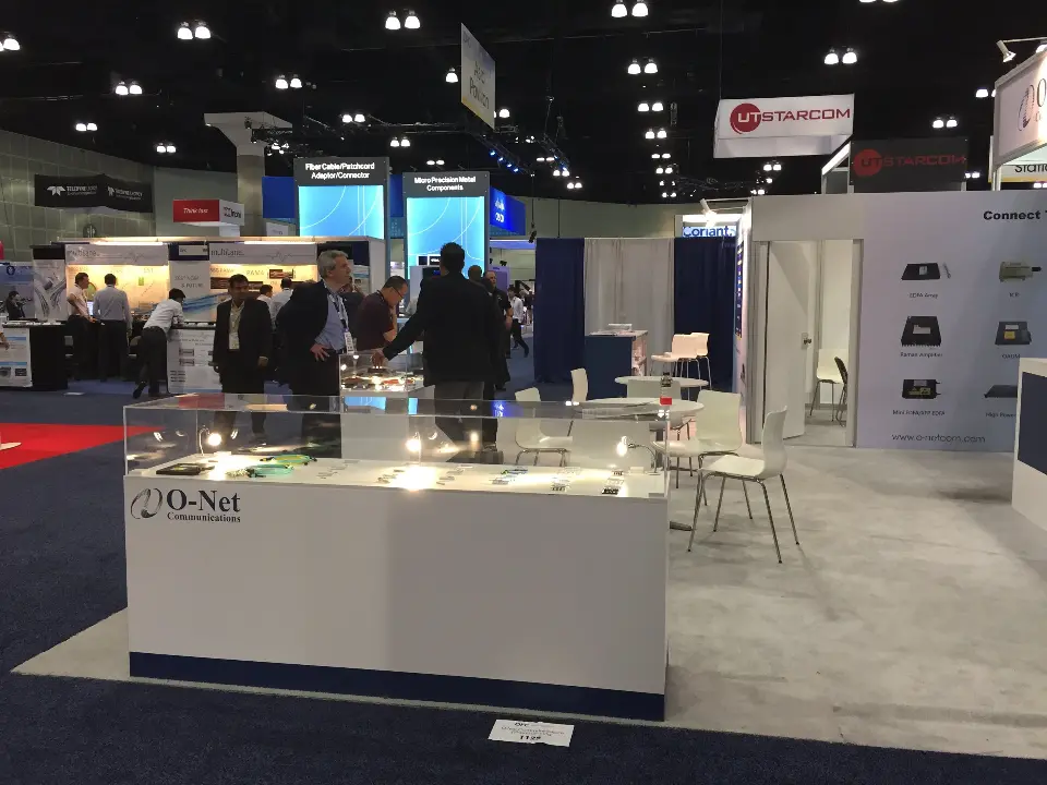 Visitors around a lit display counter with product samples