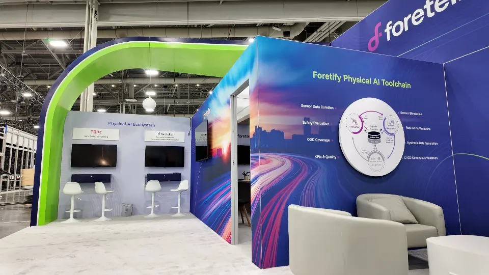 Green arch and armchairs inside the booth beside demo screens