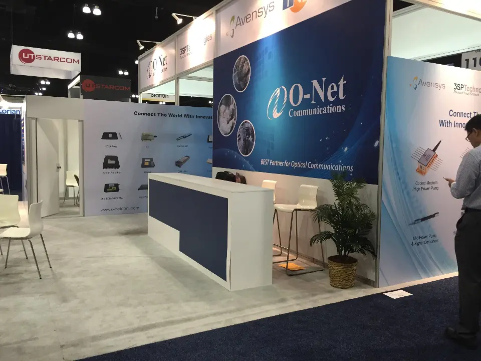 Close angle of the O-Net graphic wall, white counter and potted palm
