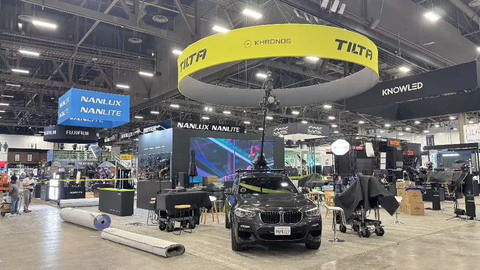 Black SUV with mounted camera rig below the yellow Tilta ring sign