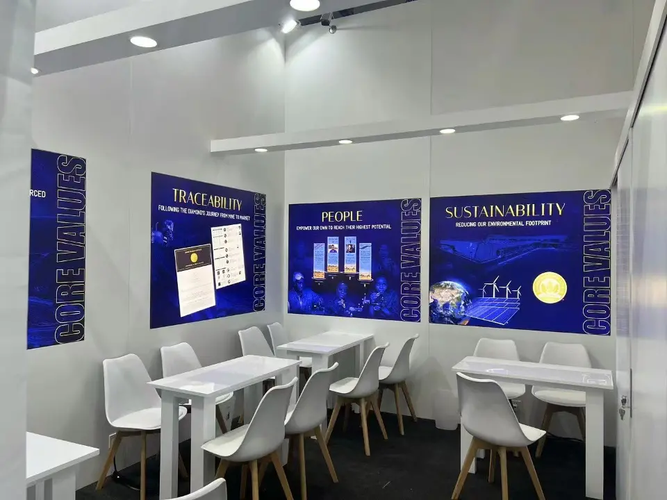 White meeting room with tables, chairs and blue Core Values panels