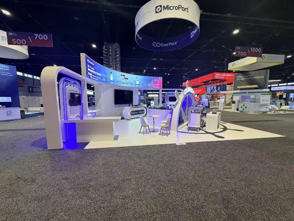 Open side under the round hanging sign with blue-lit arch kiosks