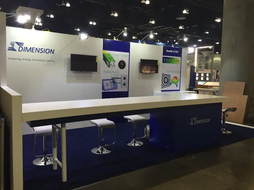 Close angle of the white bar counter with navy base and Dimension logo wall