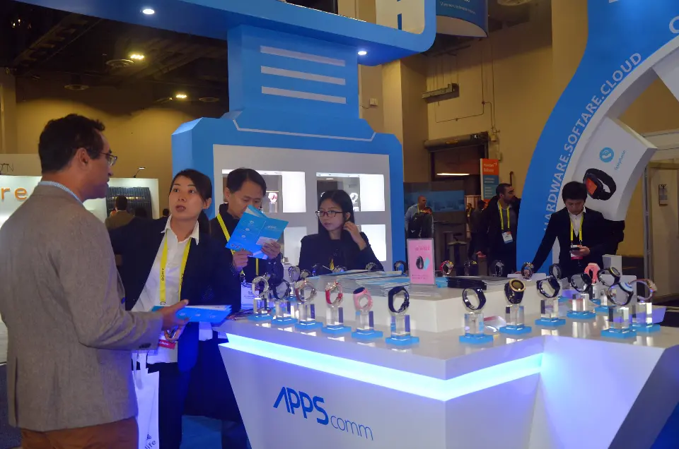 Close view of a visitor at the lit counter with the APPS logo