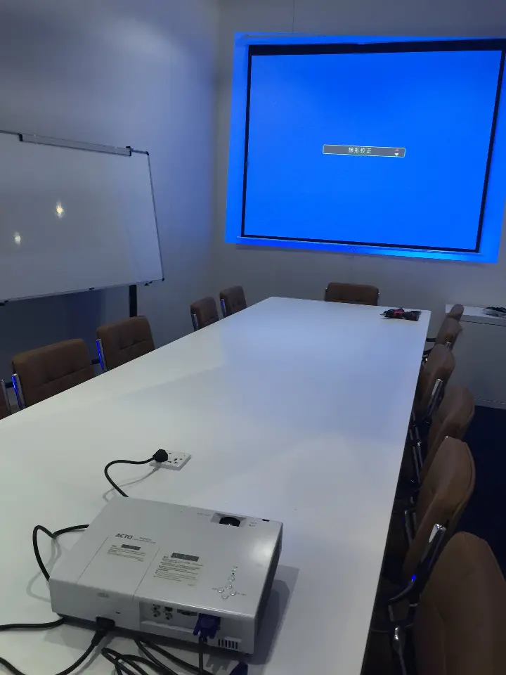 Another angle of the meeting room table and projector facing the screen