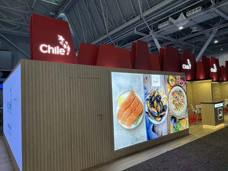 Backlit food graphics set into wood-look slat walls under the red Chile header