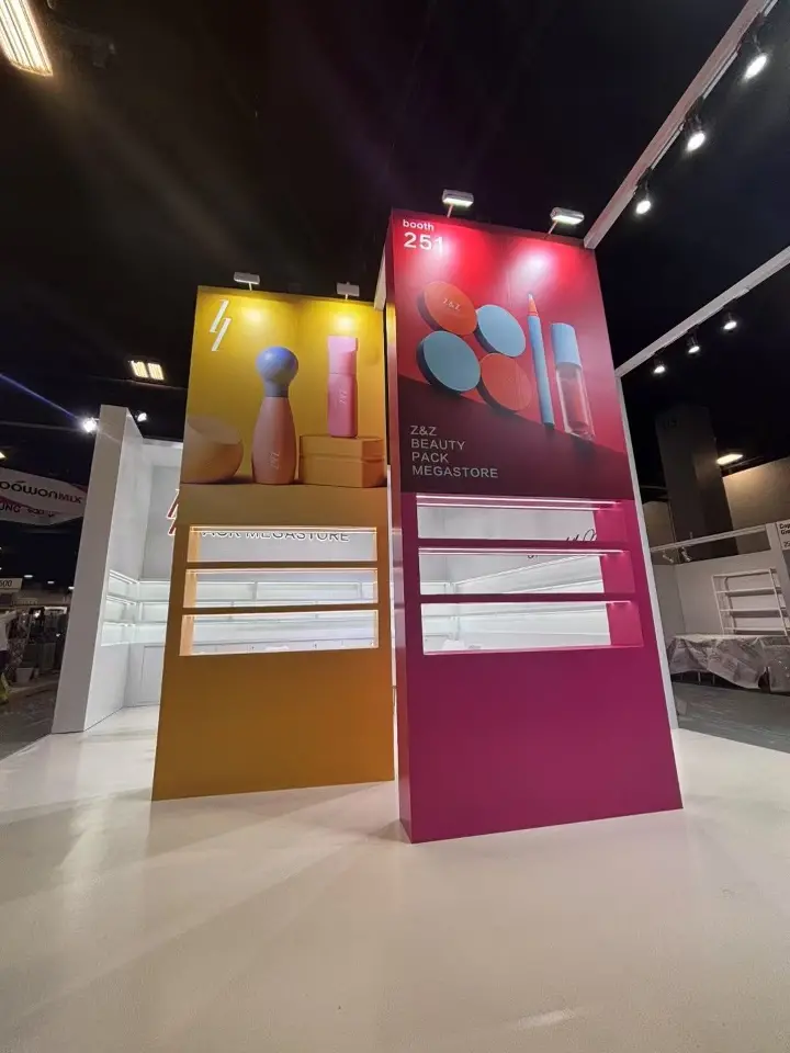 Yellow and magenta towers with beauty tool graphics above white product shelves