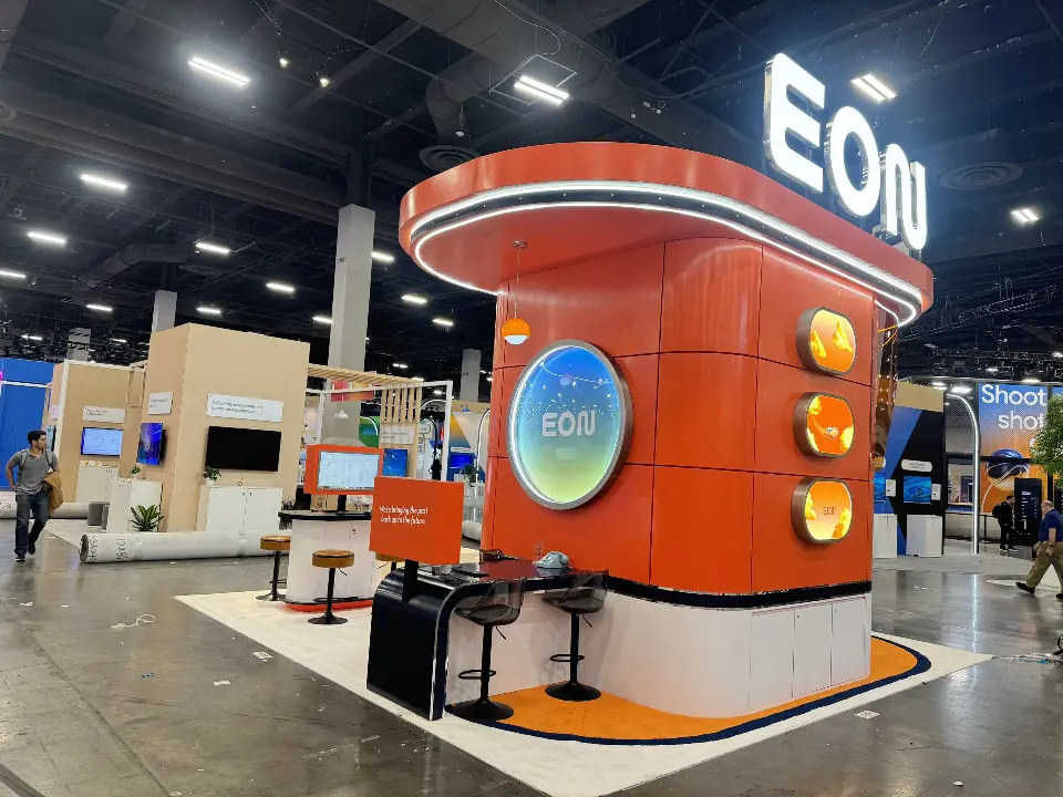 Angled view of the orange tower with round screen and lit ovals