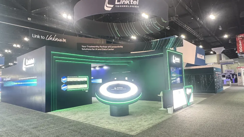 Round lit demo table with a green ring under a circular Linktel hanging sign