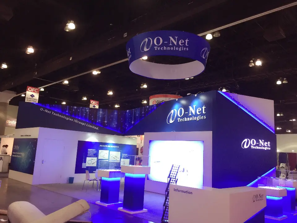 Wider front view of the navy and white booth with blue light strips along the top