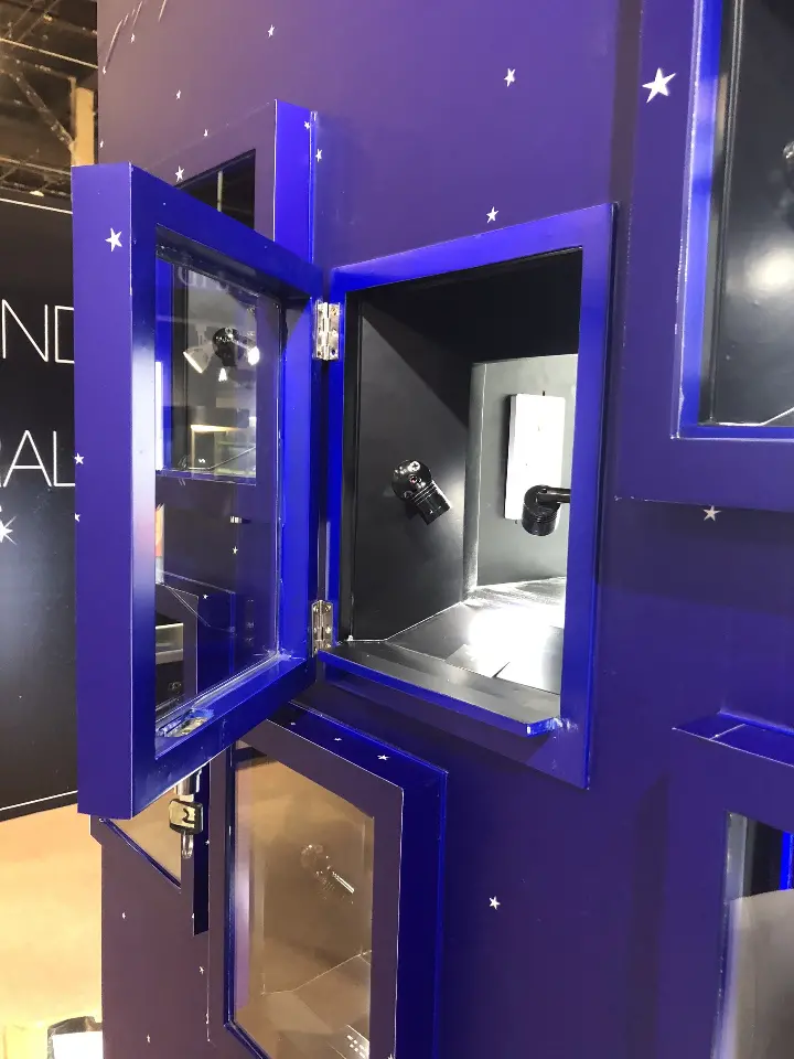 Hinged blue niche door standing open on a lit display box