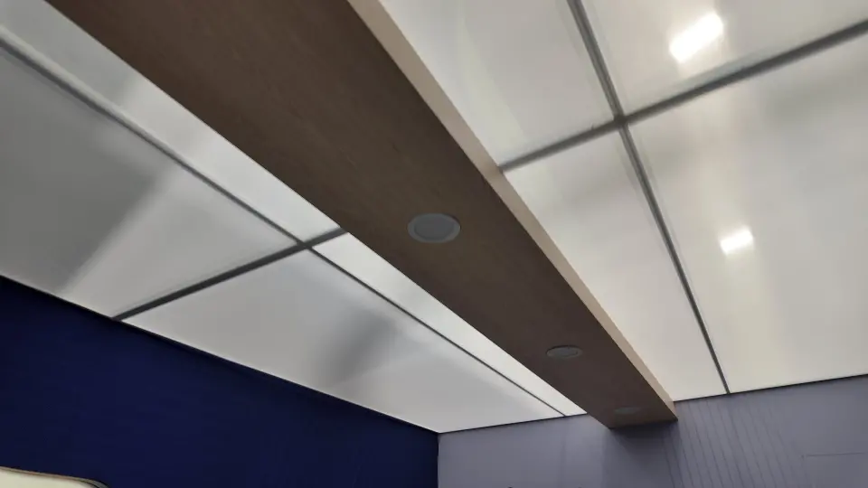 Close view of the wood-look ceiling beam and white panels