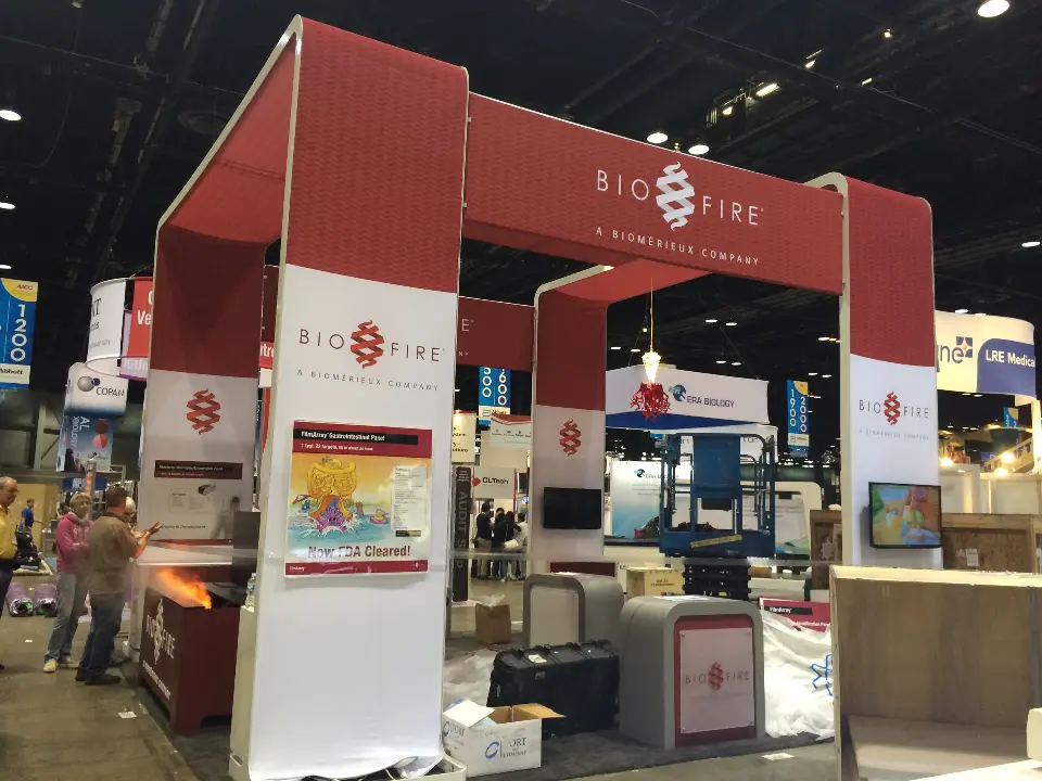 Red and white frame arches with BioFire logos, screens and grey kiosks inside