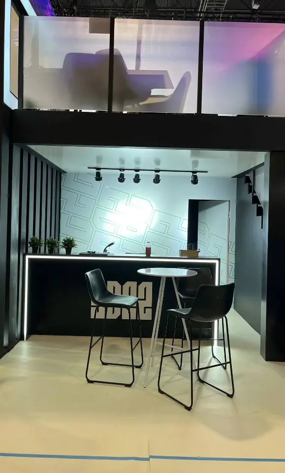 Bar counter with lit edge and SB22 lettering under track lights and frosted glass