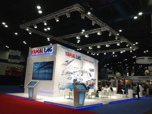 Yamal LNG white cube booth on a raised platform with video wall and kiosks