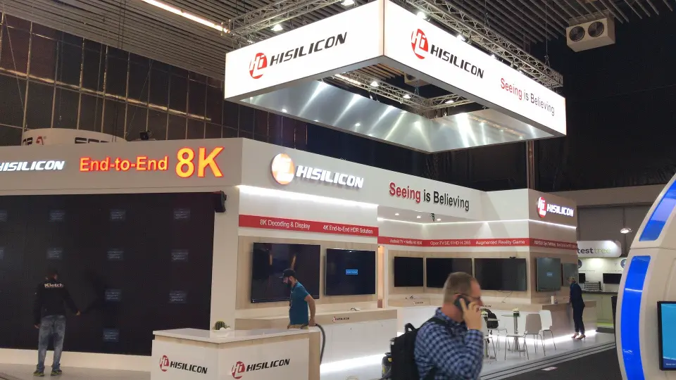 Booth front with End-to-End 8K lettering and white reception counter