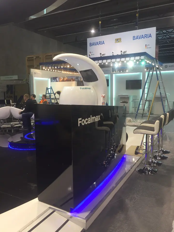 Black reception counter with Focalmax lettering and a blue light strip along its base