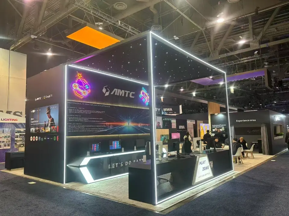 Open frame outlined by light strips with AMTC branding, black counters and dark graphics