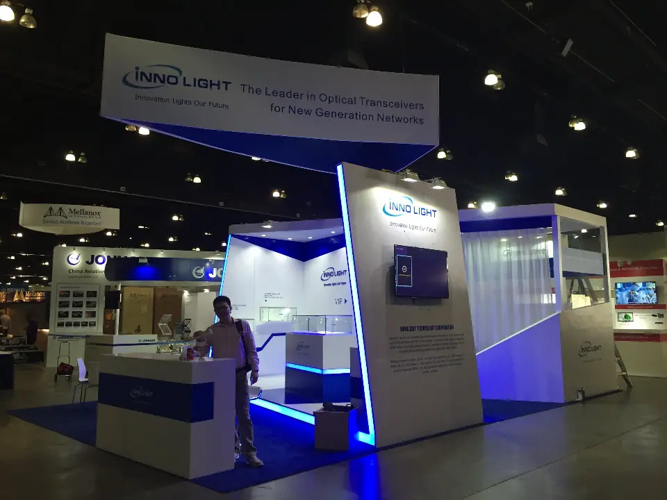 Wide view under the angled InnoLight hanging sign with podium and walls