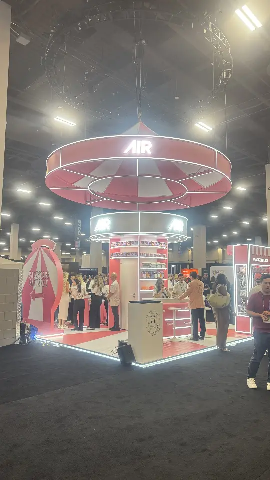 Vertical shot of the AIR booth with its ring sign and pink and white floor