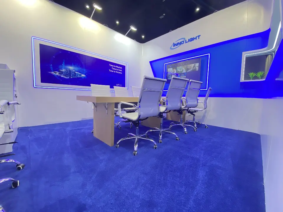 White meeting room with a long table, high-back chairs and a blue panoramic graphic