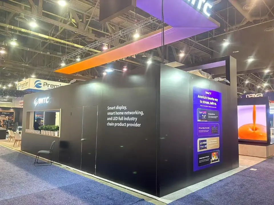Black AMTC stand corner with a purple product graphic and an orange lit ceiling band