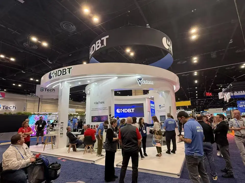 Wide view of the booth with a crowd gathered at the front