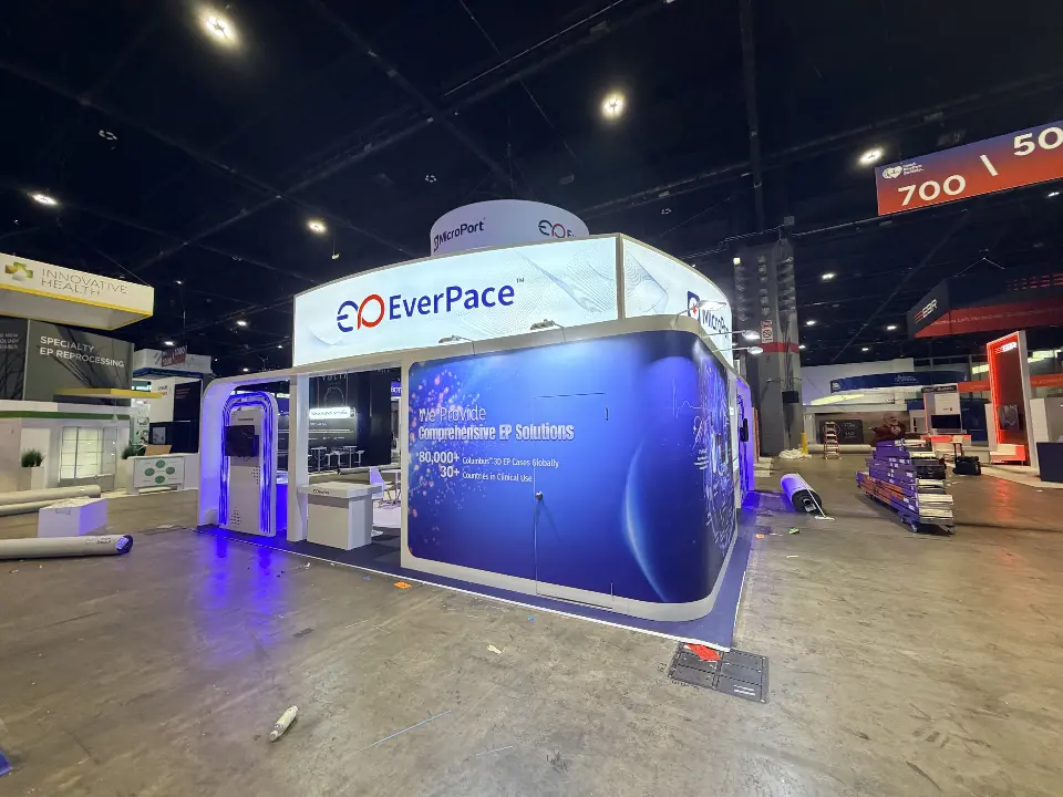 Corner view of lit EverPace and MicroPort header over a blue graphic wall