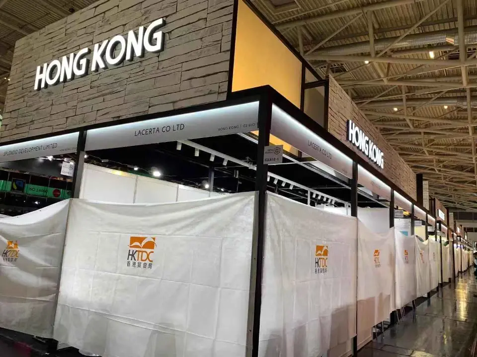 Angled view of the wood-look header box over shell booths still under white covers