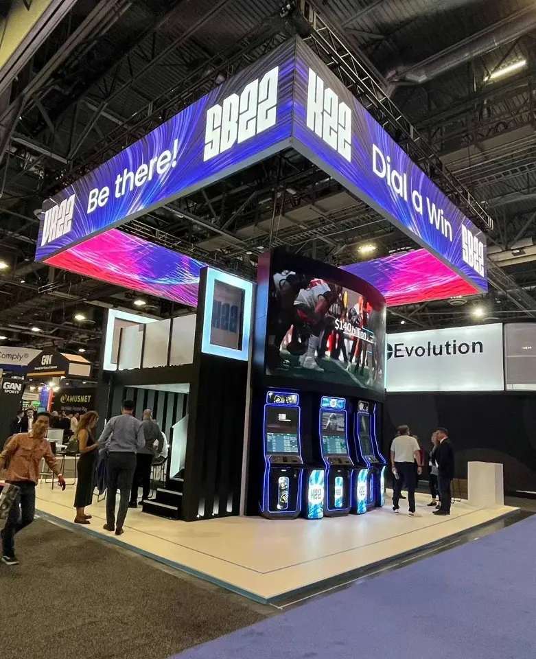Gaming cabinets lined along the front with an Evolution sign and SB22 header