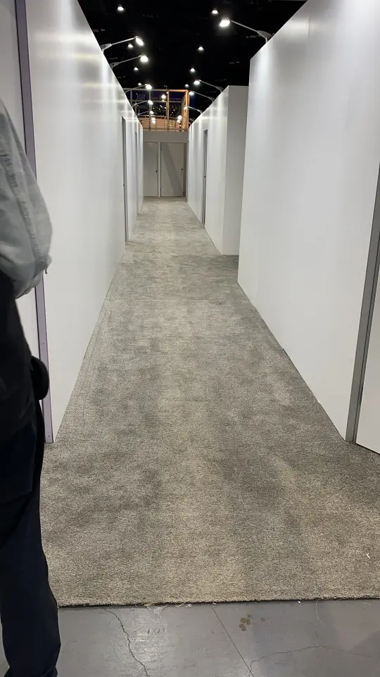 Narrow white corridor between meeting rooms in portrait view