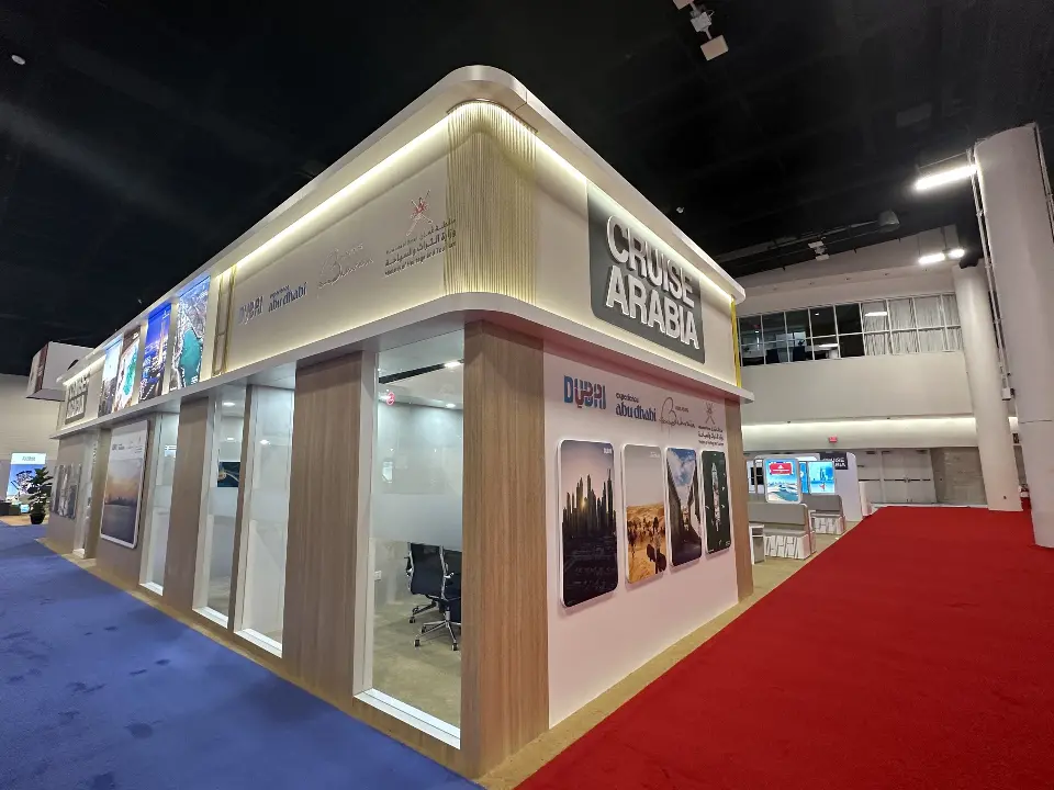 Corner view of glass meeting rooms with wood-look frame and lit edges